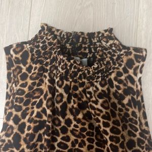 Sleeveless mock neck animal print top.
